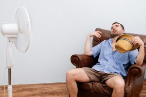 flushed-man-in-front-of-fan